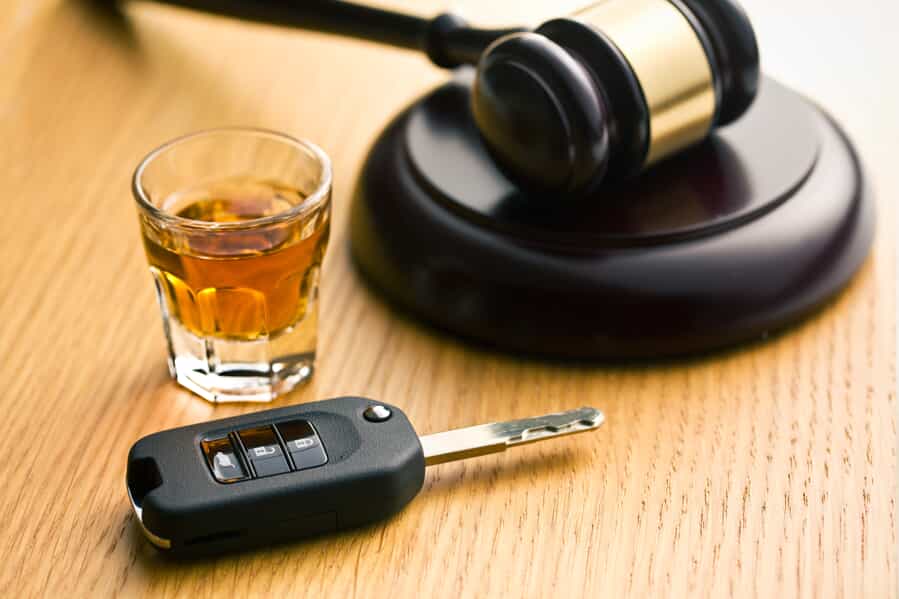 Shot of Alcohol Next to a Key and Judge Gavel